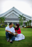 Joyful young loving couple spending time together study at the park. Leisure and enjoy the day