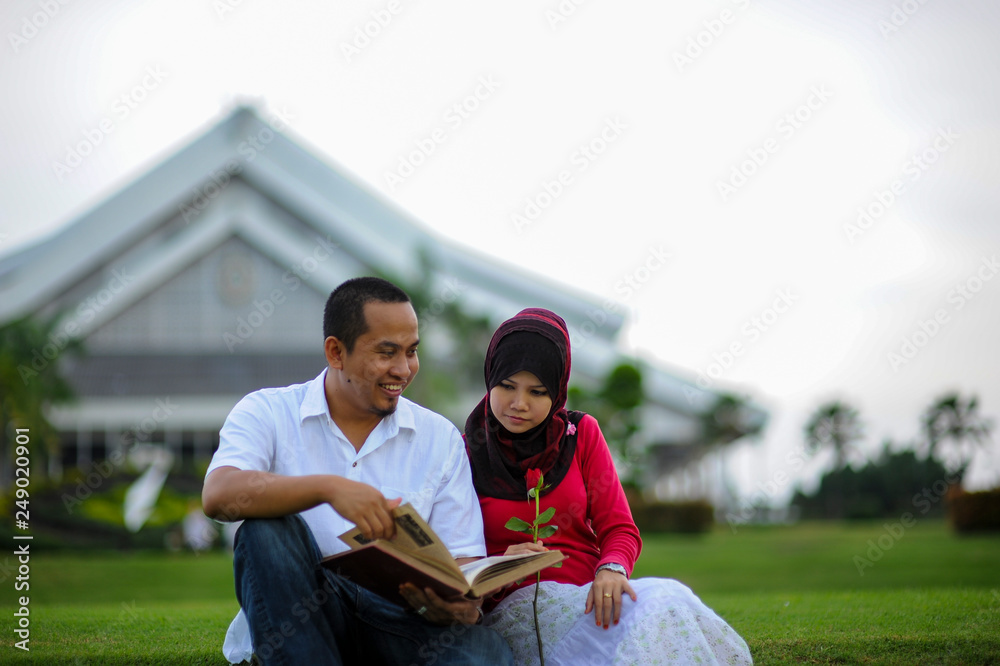 Joyful young loving couple spending time together study at the park. Leisure and enjoy the day Joyful young loving couple spending time together study at the park. Leisure and enjoy the day