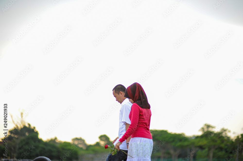 Couple outdoors enjoying a evening day looking happy together. Malay couple in Malaysia Couple outdoors enjoying a evening day looking happy together. Malay couple in Malaysia