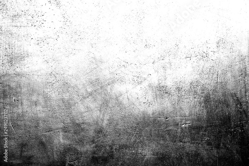 Black and white scratched grunge plaster wall texture for background with copy space on top.