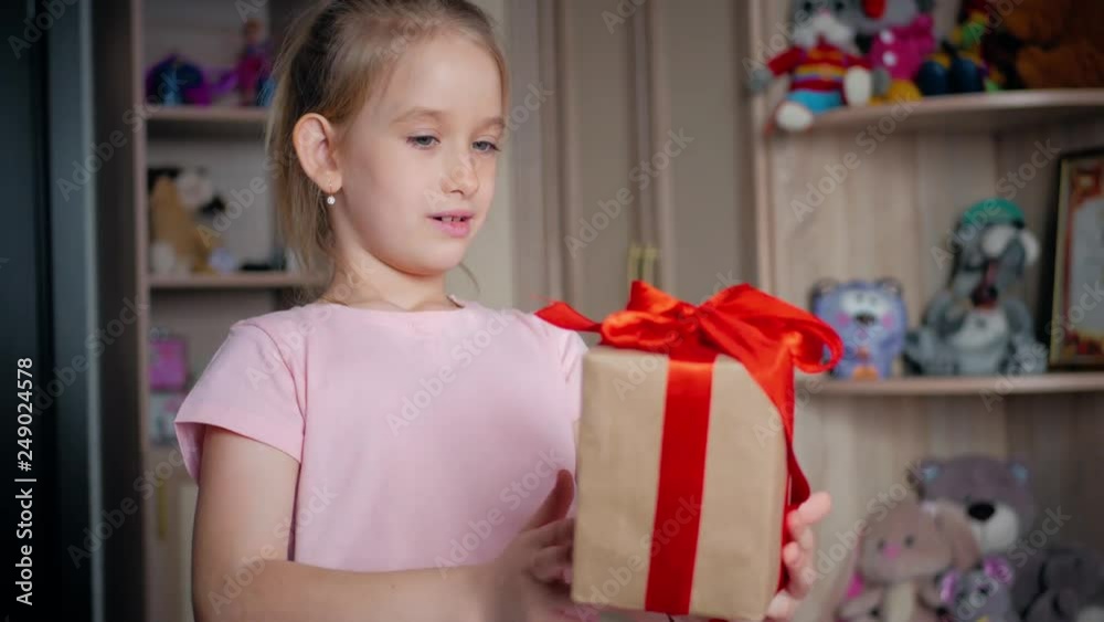 Holidays, presents, christmas, childhood and people concept - smiling little girl with gift box in his room at home. Holidays, presents, christmas, childhood and people concept - smiling little girl with gift box in his room at home.