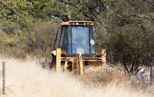 Small yellow tractor in a field