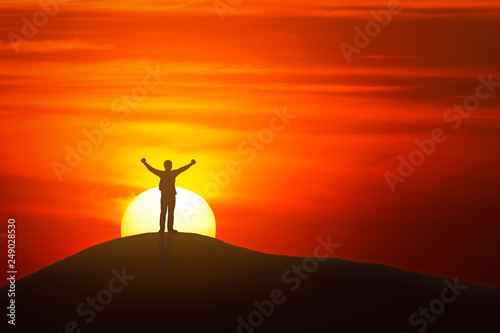 man stand at top of mountain and sunrise background .success concept