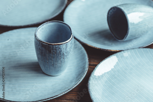 Fotografía Handmade blue set of ceramic tableware. Espresso cups and plates.