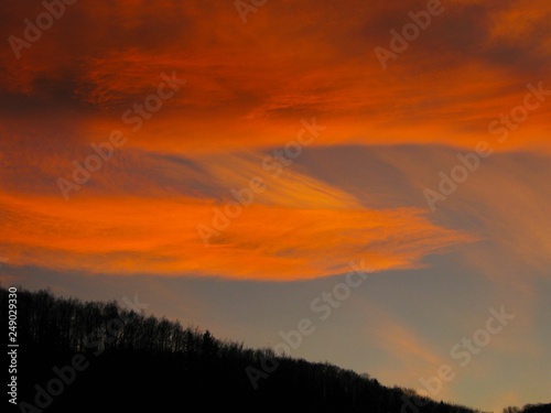 Evening sky with a cloud in the red tones of sunset © maria