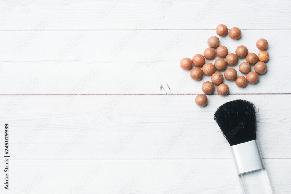Balls blush and a cosmetic brush. Selective focus. Copy space Balls blush and a cosmetic brush. Selective focus. Copy space