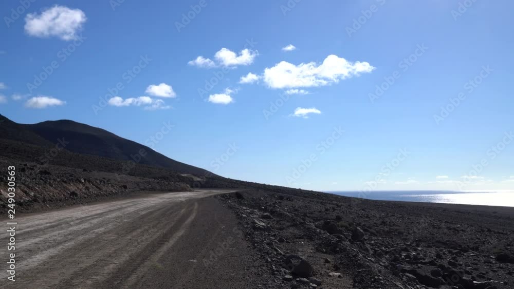 Earth Road near the Atlantic Ocean. Fuerteventura, Island of Spain Earth Road near the Atlantic Ocean. Fuerteventura, Island of Spain