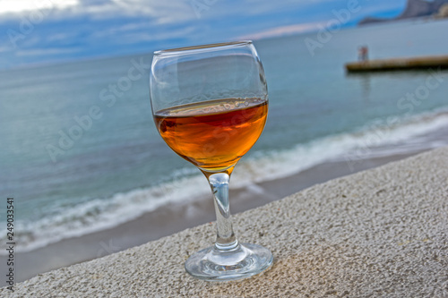 A glass of wine on the background of the sea.