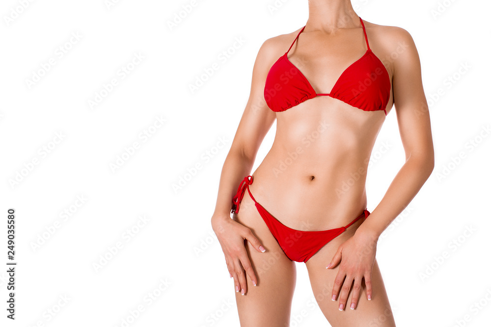 Female cropped sexy tanned fit body in red classic bikini, isolated on white Female cropped sexy tanned fit body in red classic bikini, isolated on white