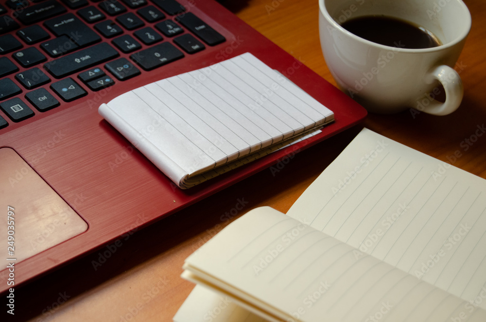 home office desk, red laptop, coffee, notebooks, diary, pen home office desk, red laptop, coffee, notebooks, diary, pen