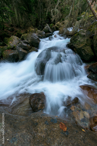 river in the mountains. mountainous area. photo on a long exposure, cloudy day. waterfalls in the mountains in the forest