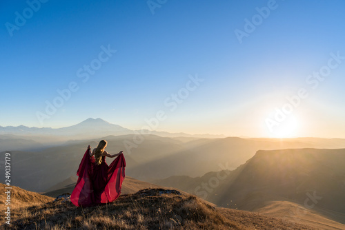 photo shoot in the mountains. girl in a dress against the mountains. at sunset