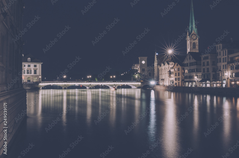 Naklejka premium Night view of historic Zurich city center with famous Fraumunster Church