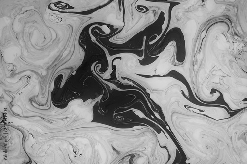 Abstract monochrome marble background. Stains of paint on the surface of the water.