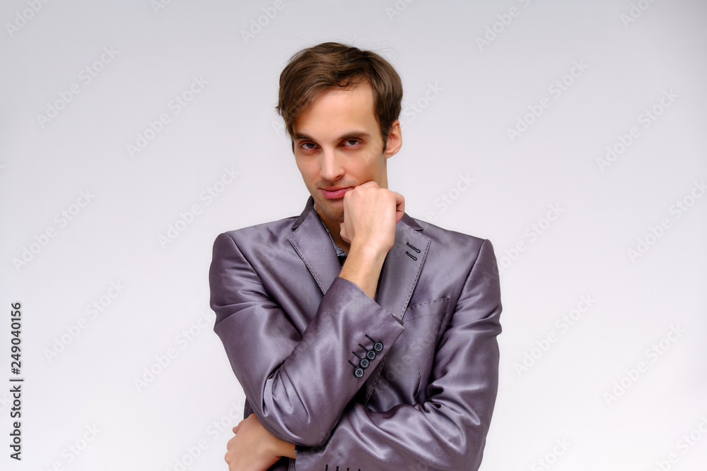 Studio concept Portrait of a handsome young man isolated on a white background with different emotions in a jacket and shirt in silver. Studio concept Portrait of a handsome young man isolated on a white background with different emotions in a jacket and shirt in silver.
