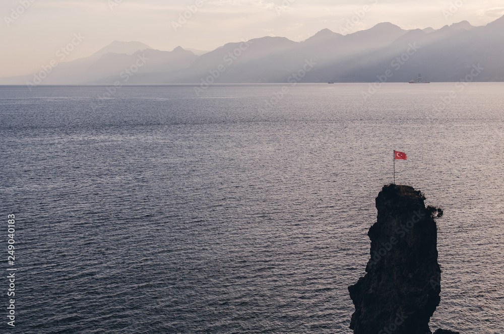 Alone Turkey flag on the rock in Antalya, Turkey