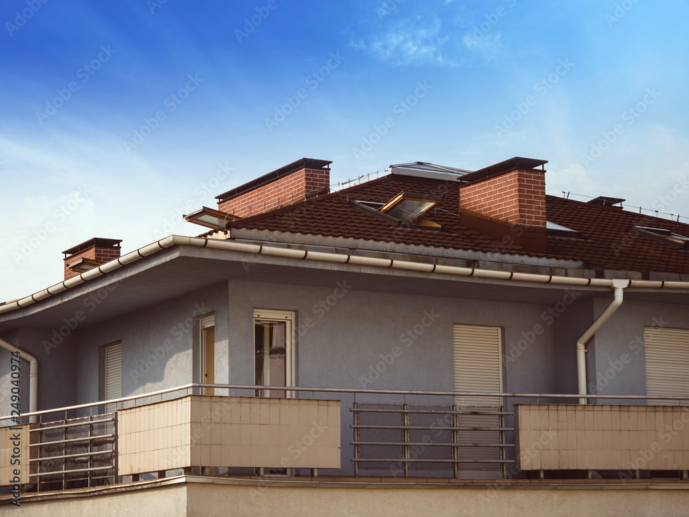 Modern, flat, block with a big balcony. Close-up with blue sky.