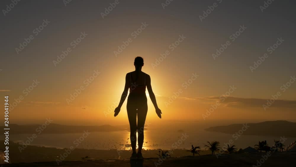 Woman silhouette doing yoga fitness exersice at sea beach in sunrise. Woman silhouette doing yoga fitness exersice at sea beach in sunrise.
