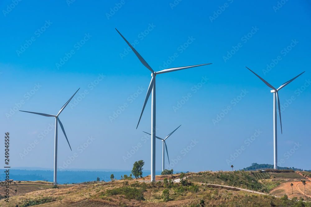 Power of wind turbine generating electricity clean energy with cloud background on the blue sky.Global ecology.Clean energy concept save the world. Power of wind turbine generating electricity clean energy with cloud background on the blue sky.Global ecology.Clean energy concept save the world.