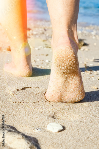 Beautiful traces with feet on sea nature background