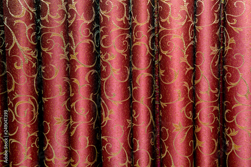 Burgundy beautiful portieres in a flat vertical fold photo