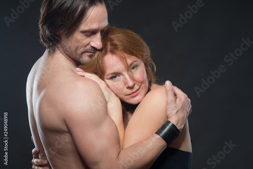 Pleased positive woman embracing her smiling husband with tenderness