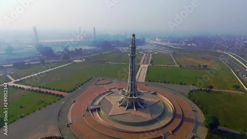 Aerial rotating view of Minar-e-Pakistan with city and Mughal`s Famous Badshahi Mosque, A national monument located in¬†Lahore,¬†Pakistan photo