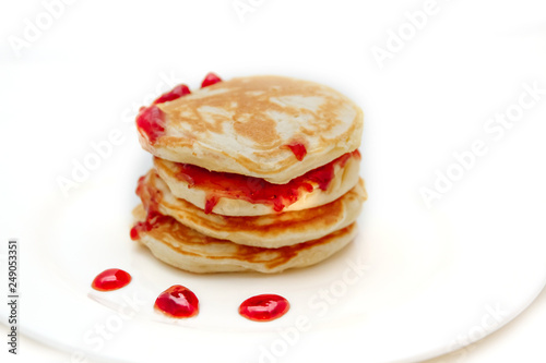 Pancakes with strawberry jam white plate
