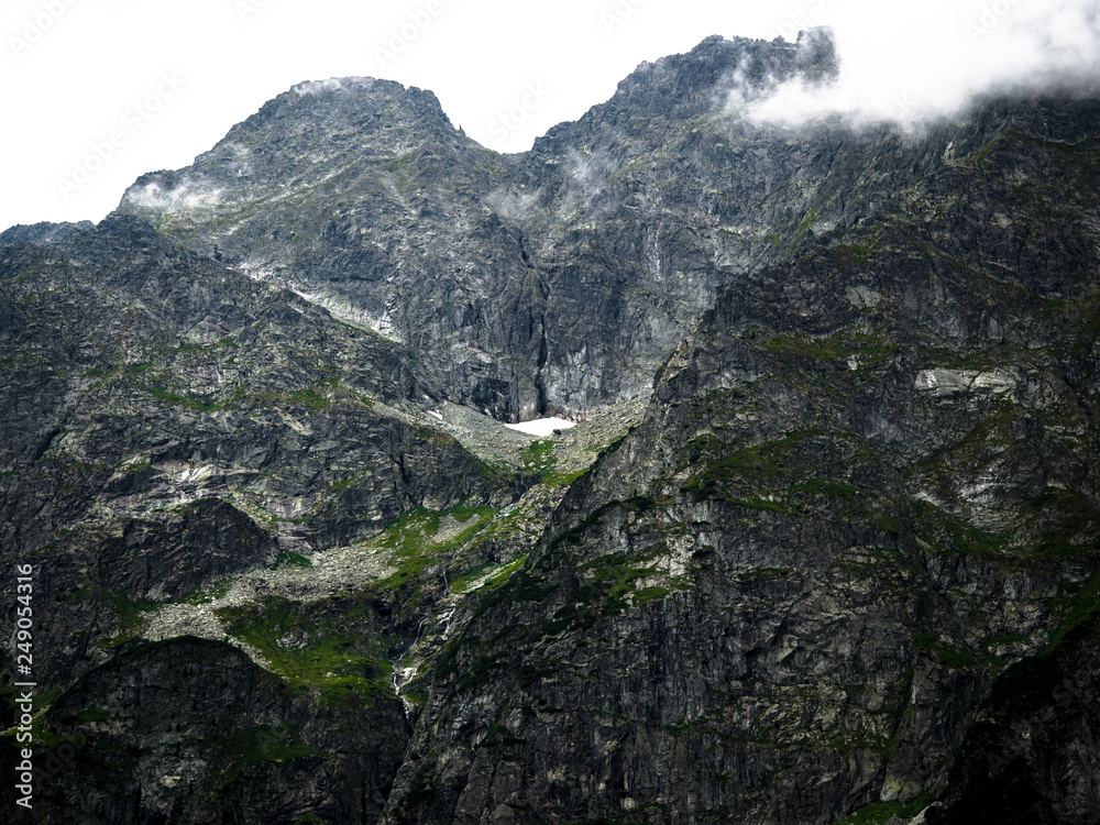 Tatra Mountain part of Carpathian mountain chain in eastern Europe create natural border between Slovakia, Poland. Both protected as national parkland popular destination for winter, summer sports.