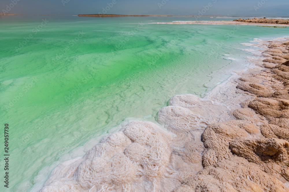 Crystallized salt cover the beach of Dead Sea in Israel.
