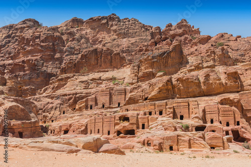 View of large cliff side tomb carved from the beautiful richly colored sandstone in the ancient city of Petra, Jordan.