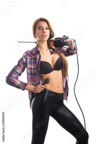 Beautiful woman with heavy drill in her hands