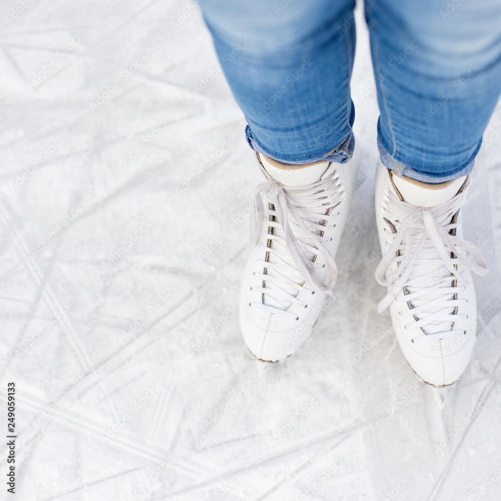 top view of legs in skates over ice top view of legs in skates over ice