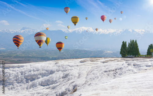 Collage with hot air ballons flying above snowy white Pamukkale in Turkey photo