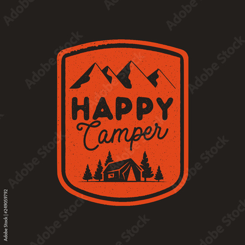 Hand drawn travel badge with mountains, trees, tent and quote - Happy camper. Camping emblem in retro style. Stock vector wanderlust label isolated