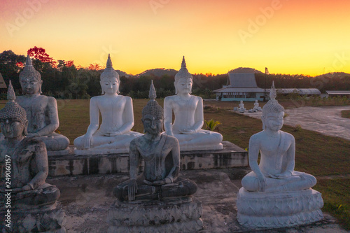 aerial view gold and white Buddha statues in the field  at Tungsong Nakornsrithammarat © Narong Niemhom