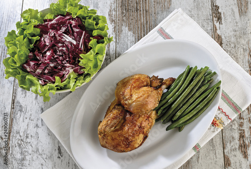 mezzo pollo con fagiolini e insalata da sopra photo