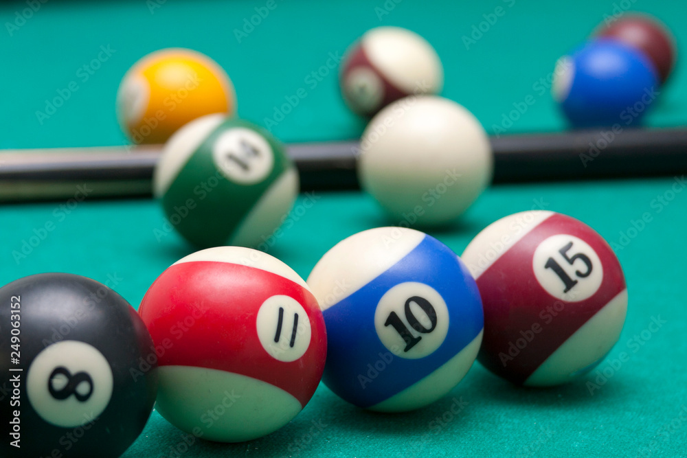 Lots of billiard balls and a cue closeup, macro shot of a professional competitive billiard table Lots of billiard balls and a cue closeup, macro shot of a professional competitive billiard table