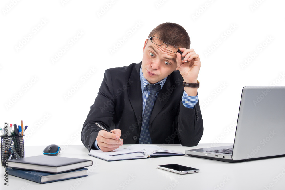 Surprised businessman with laptop computer and documents at office on gray background Surprised businessman with laptop computer and documents at office on gray background