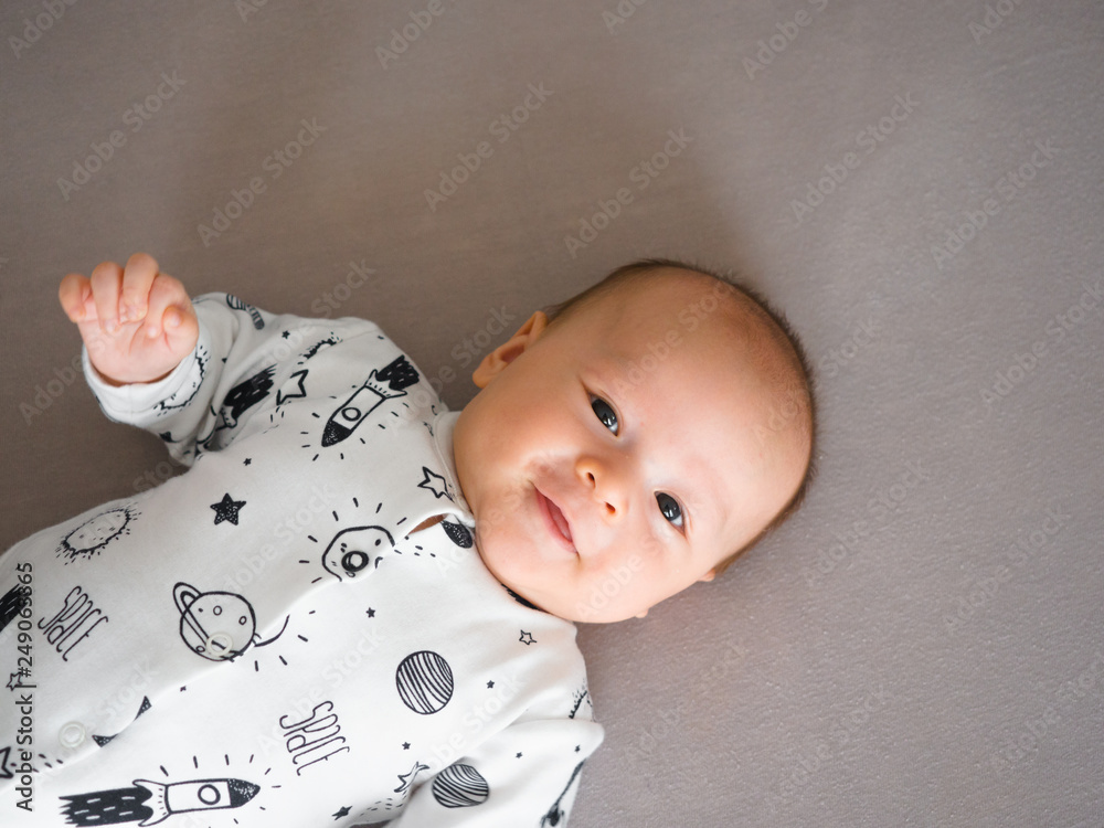 Cute 3 months old old mixed race Asian Caucasian boy looking at the camera,  healthy child baby boy. Half Thai half Polish, wearing baby bodysuit with  copy text space. Stock Photo