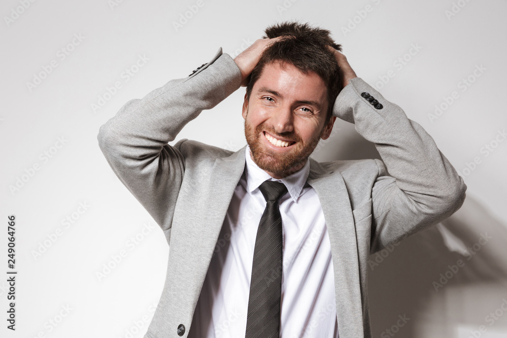 Laughing young businessman in formal clothes isolated over white wall background. Laughing young businessman in formal clothes isolated over white wall background.