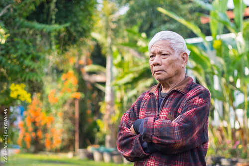 Portrait of elderly man standing in his garden.