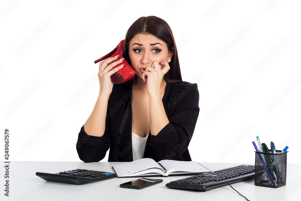 Young business woman using a shoe like a telephone holding it near her face and talking Young business woman using a shoe like a telephone holding it near her face and talking