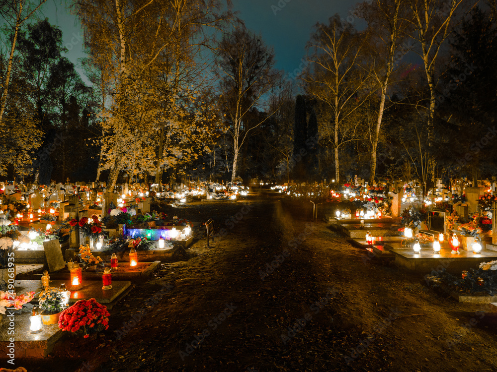 All Hallows' Day, Feast, Solemnity, Christian festival celebrated of all saints, Cemetery decorated with candles for All Saints Day at night on 1st November.