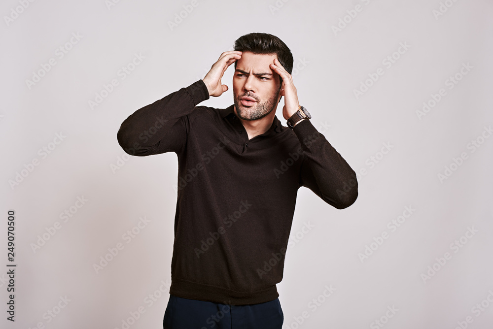 No way! Stylish dark-haired man standing in a state of shock and looking away isolated over grey background No way! Stylish dark-haired man standing in a state of shock and looking away isolated over grey background