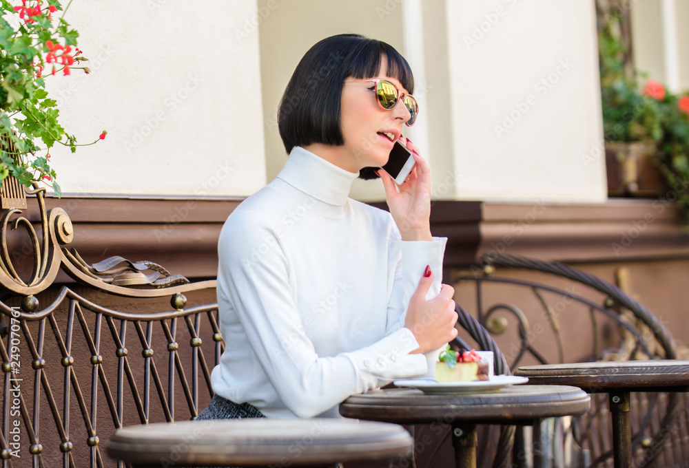 Pleasant time and leisure. Call friend. Relax and coffee break. Girl fashionable lady with smartphone. Leisure concept. Woman attractive elegant brunette spend leisure cafe terrace background