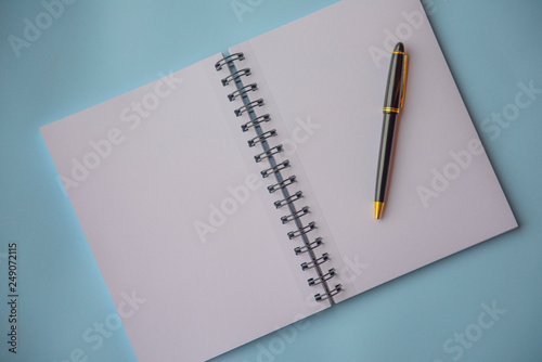 Plain empty notebook, on a blue background with copy space