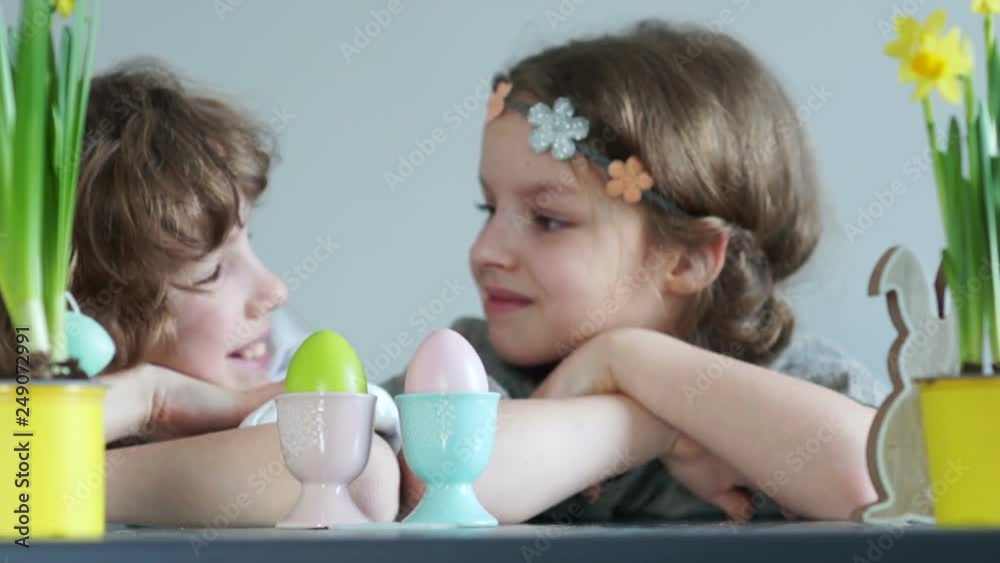 Easter decor. Lovely boy and girl look at each other. Easter family holiday, school friendship Easter decor. Lovely boy and girl look at each other. Easter family holiday, school friendship