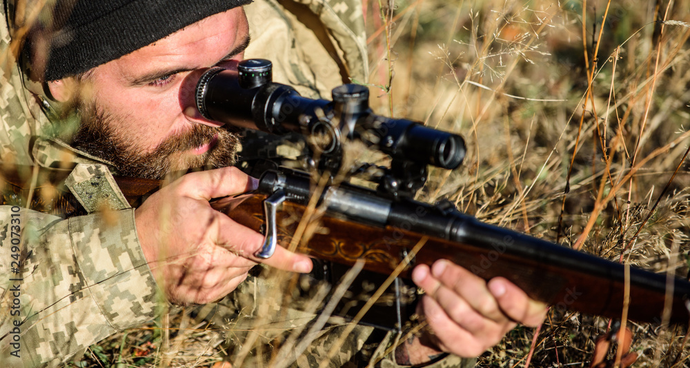 Man hunter with rifle gun. Boot camp. Bearded man hunter. Army forces. Camouflage. Military uniform fashion. Hunting skills and weapon equipment. How turn hunting into hobby. Strict verdict Man hunter with rifle gun. Boot camp. Bearded man hunter. Army forces. Camouflage. Military uniform fashion. Hunting skills and weapon equipment. How turn hunting into hobby. Strict verdict