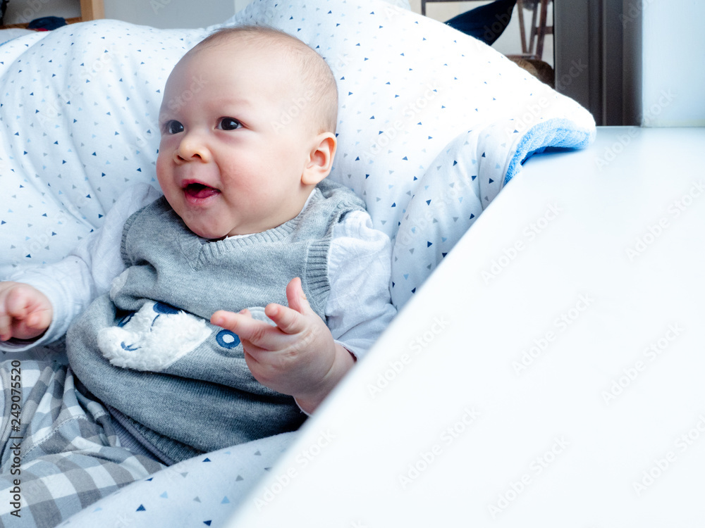 Cute 4 months old mixed half race Asian Caucasian boy looking happy smiling  and laughing at